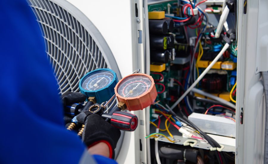 HVAC technician inspecting and servicing commercial air conditioning equipment