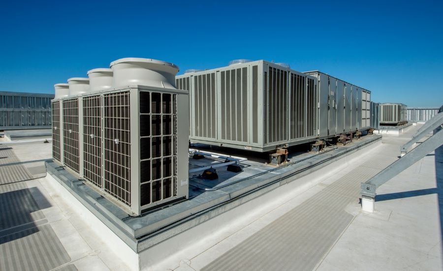 Chilled water pipes and HVAC equipment in a commercial building plant room